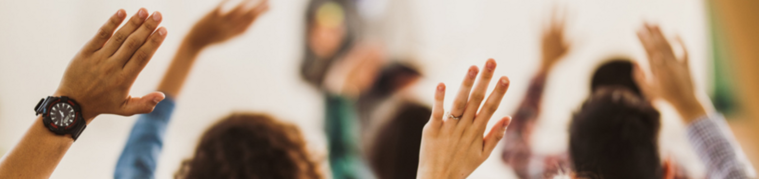 hands raised in a classroom