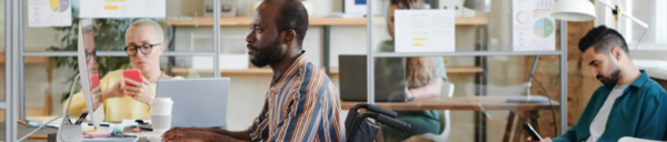 person in wheelchair sitting at a desk