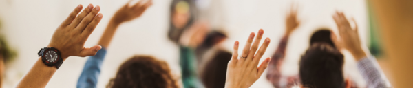 hands raised in a classroom